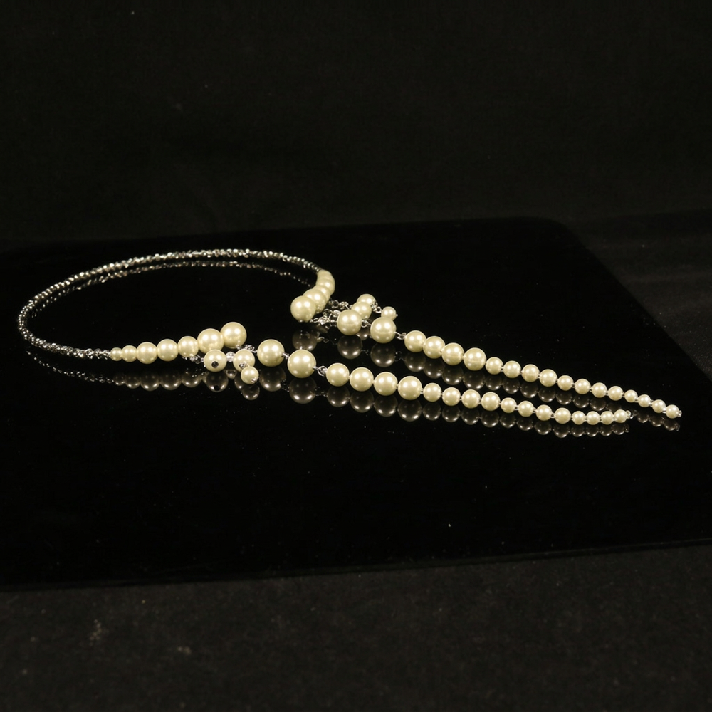 Necklace on black surface with text removed