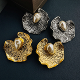 Mixed gold and silver earrings with text removed