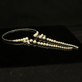Necklace on black surface with text removed